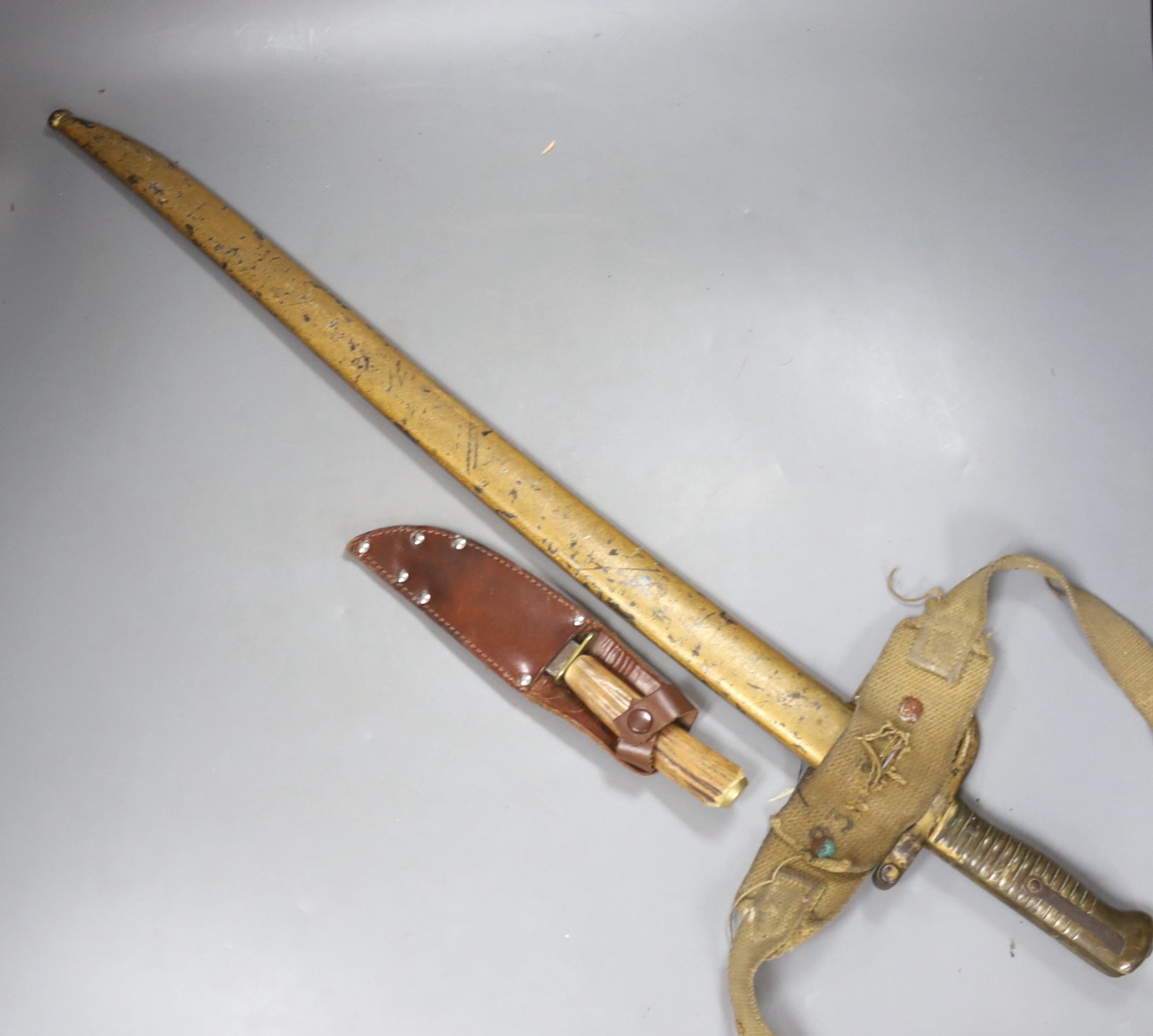A bayonet with scabbard and a knife, bayonet 71 cms long.